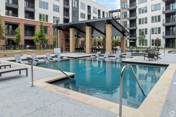 Retreat-style pool with in-water tanning ledge, plunge pool and expansive deck